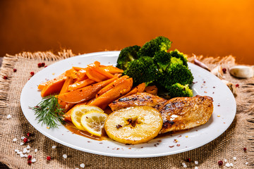 Grilled chicken breast, French fries and vegetable salad