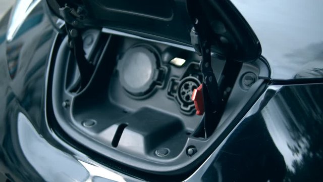 A nozzle is being removed from an electrocar