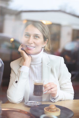 Happy young blonde woman in white suite