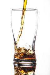 pouring cola into glass with ice on white background Copy space