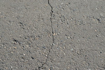 Obraz premium Asphalt surface texture with crack.