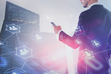 Man looking at phone in city, social media