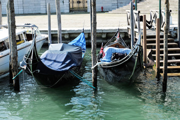 Fototapeta na wymiar two gondolas moored on Grand Canal in VEnice, Italy