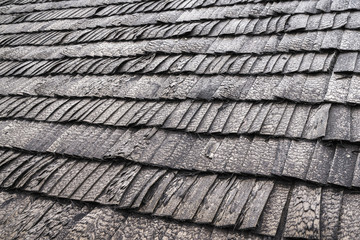 roof wood shingles in close-up; gray natural background; abstract background arranged in rows