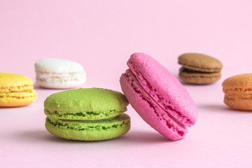 Beautiful multicolored macaroons on pastel pink background.