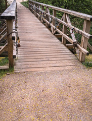 a large pedestrian bridge made of wood; bridge across the ravine;