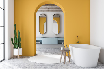 Yellow arched bathroom interior, tub and sink