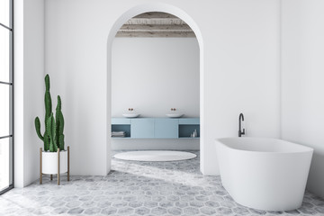 White arched bathroom interior, tub and sink