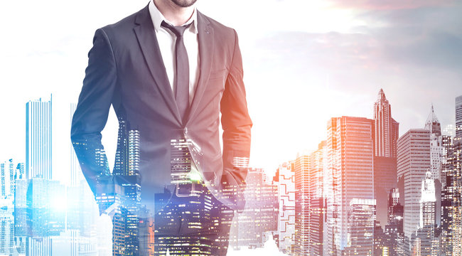 Confident young businessman in modern city