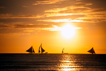 Fototapeta na wymiar Sailboats on the sea, sunset scenery