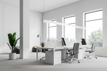 White open space office corner with windows