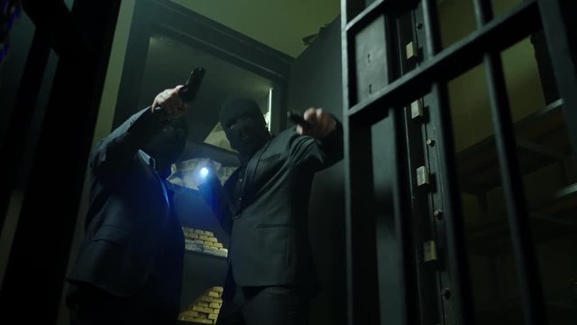 Two ardmed men robbing a bank