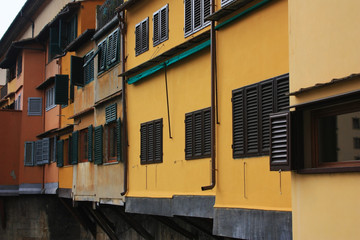 Fototapeta na wymiar Old Italian houses with shutters on the windows