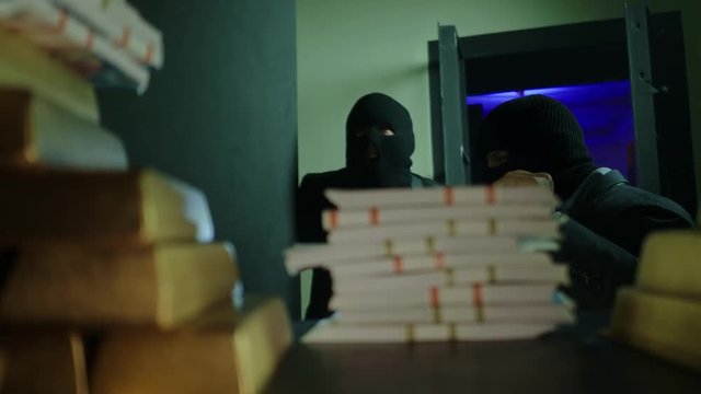 Two ardmed men robbing a bank