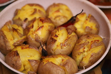 Homemade baked potatoes with garlic and pepper.