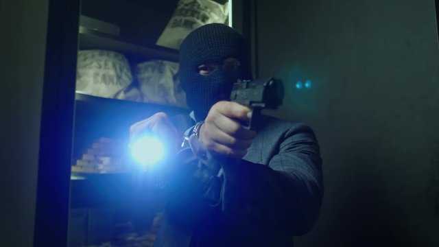 Man in mask robbing a bank