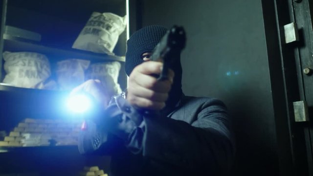 Man in mask robbing a bank