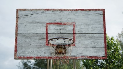 old basketball hoop with sky background © Nattares
