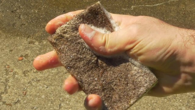 Squeezing A Car Wash Sponge