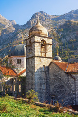 Fototapeta na wymiar Religious architecture. Montenegro, Old Town of Kotor - UNESCO World Heritage site. Domes of Orthodox Church of St. Nicholas, and belfry of church of St. Clare, view from Town Wall