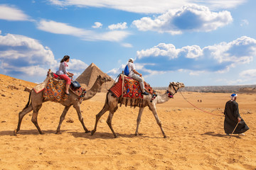 Tourists on camels near the Great Egyptian Piramds, Giza