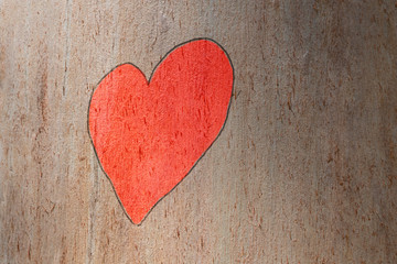 Obraz na płótnie Canvas Love heart hand painted on a trunk tree. Love concept
