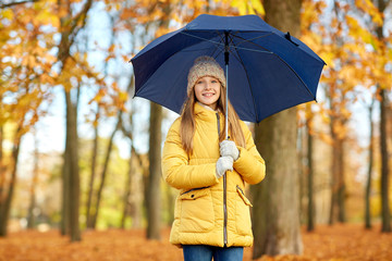 season and weather concept - happy girl with umbrella at autumn park