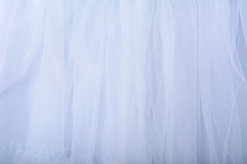 Blue fabric texture background. The skirt is made of tulle