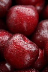 Ripe and fresh berries of a sweet cherry with water drops closeup.