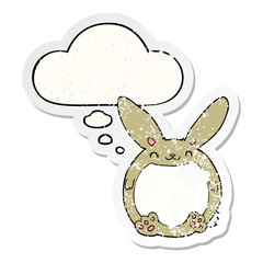 cartoon rabbit and thought bubble as a distressed worn sticker