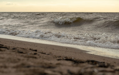 Wonderful views of the Golden sand of the beach by the sea with waves on the background of a...