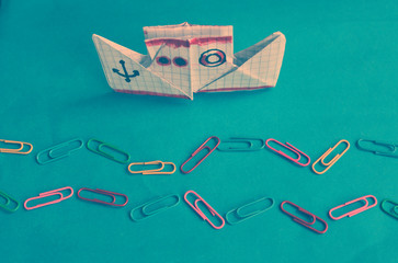 new school year card/ paper boat and waves of color clips on the blue paper background/inscription "back to school"