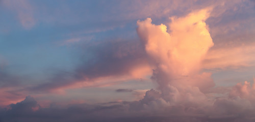 Fototapeta na wymiar Beautiful Panoramic View of a Dramatic Cloudscape during colorful sunrise.