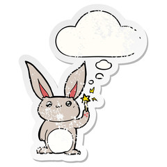 cute cartoon rabbit and thought bubble as a distressed worn sticker