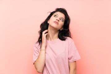 Fototapeta na wymiar Young woman over isolated pink background thinking an idea