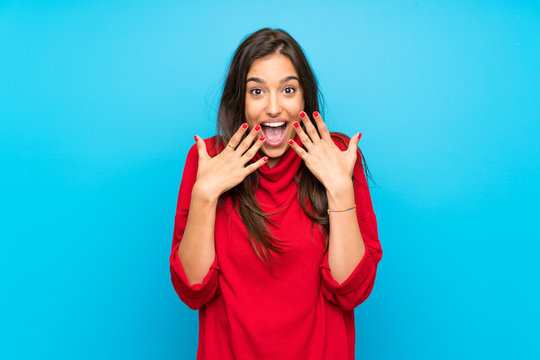 Young woman with red sweater over isolated blue background with surprise facial expression