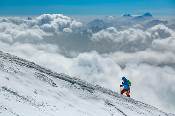 Naklejka na ściany i meble mountaineer climbing mount Elbrus in winter
