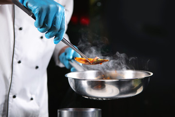 Cooking dishes from mussels in front of visitors to the restaurant. Food show in a restaurant....