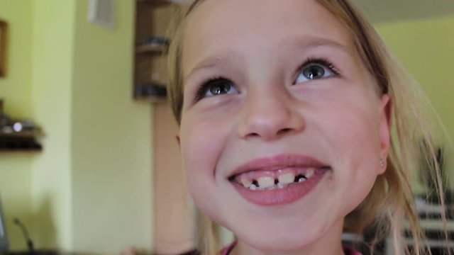 funny girl with teeth,A funny girl shows her big teeth in the camera