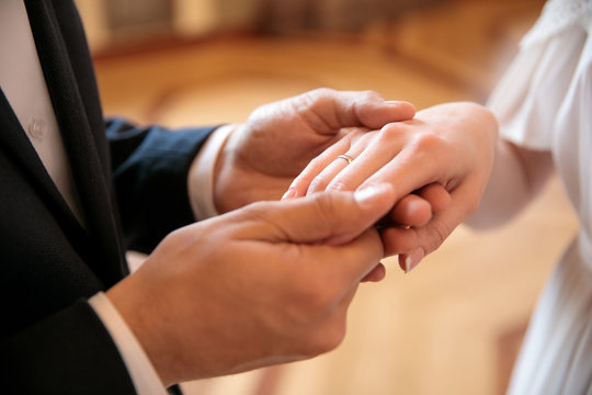 the bridegroom puts the ring on the bride and holds her hand