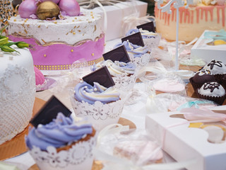 Many delicious cupcakes are on the table.