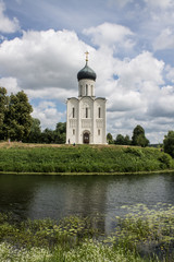 White stone Church of the Intercession on the Nerl with reflection in the water summer day Russia
