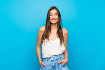Young woman over isolated blue background laughing