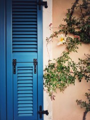 Closed window with blue shutters