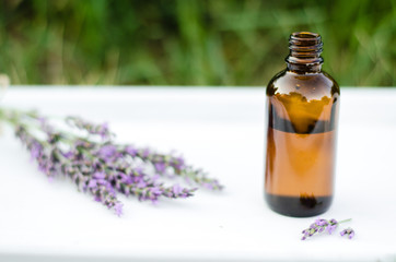 Lavender essential oil. Dark bottle of essential oil with fresh lavender twigs.  natural face and body beauty care concept.