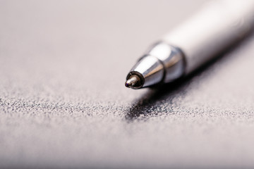 automatic silver plastic ballpoint pen with clipping path on black background. close up.