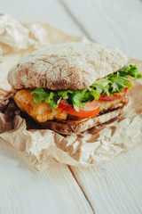 fried fish Sandwich with lettuce, tomato with tartar sauce. author's recipe street food