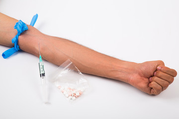 .Drug addiction, male using drugs in syringe, white and isolated background