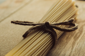 Close up of natural string rope bow on spaghetti bunch