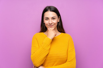 Fototapeta premium Young woman over isolated purple background laughing
